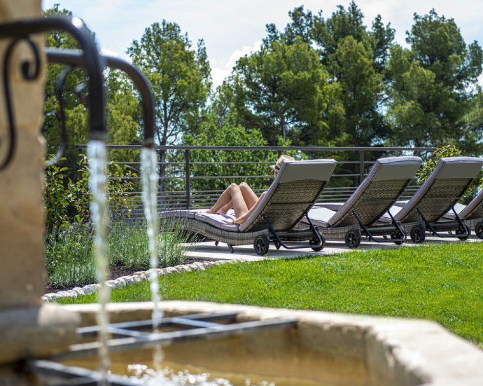 Person sunbathing on a deckchair at the Bastide de Tourtour - hotel spa var